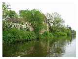 Heading upstream you pass the pretty lawns of a converted oast house 