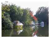 Boats moored at the end of gardens